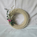 Handmade crochet wreath with dried flowers and greenery, cozy home decor accent