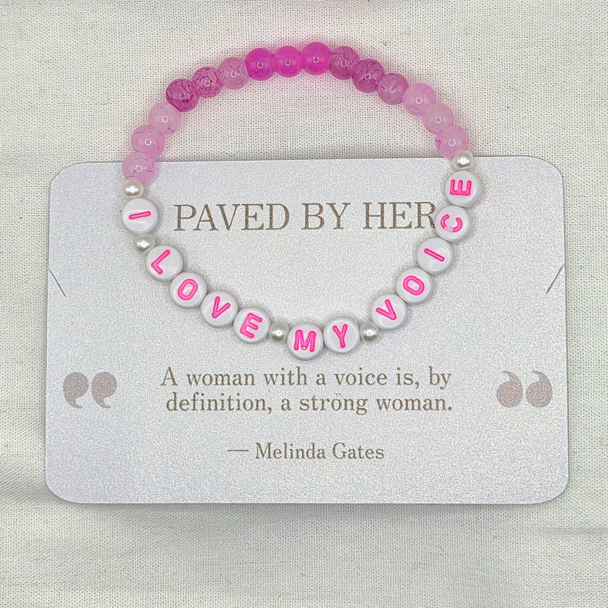 Pink and white beaded bracelet with 'LOVE MY VOICE' letter beads, displayed on a card with empowering quote.