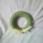 Handmade green crochet wreath with dried flowers and pampas grass, cozy home decor