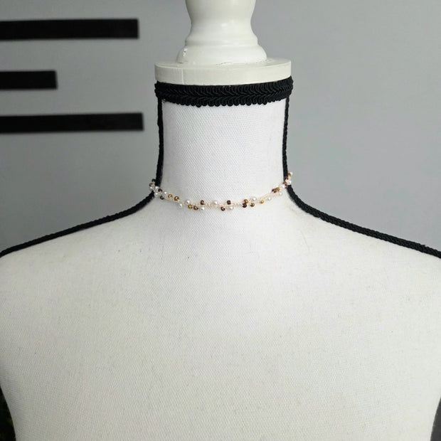 Handmade beaded choker necklace with pearls and gold beads on mannequin, cozy crochet gift