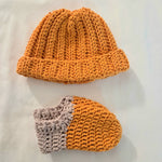 Handmade crochet hat and booties set in warm orange and gray, cozy baby gift