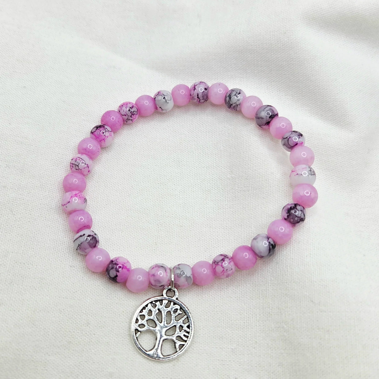Pink beaded bracelet with tree of life charm, handmade for cozy, creative gifting