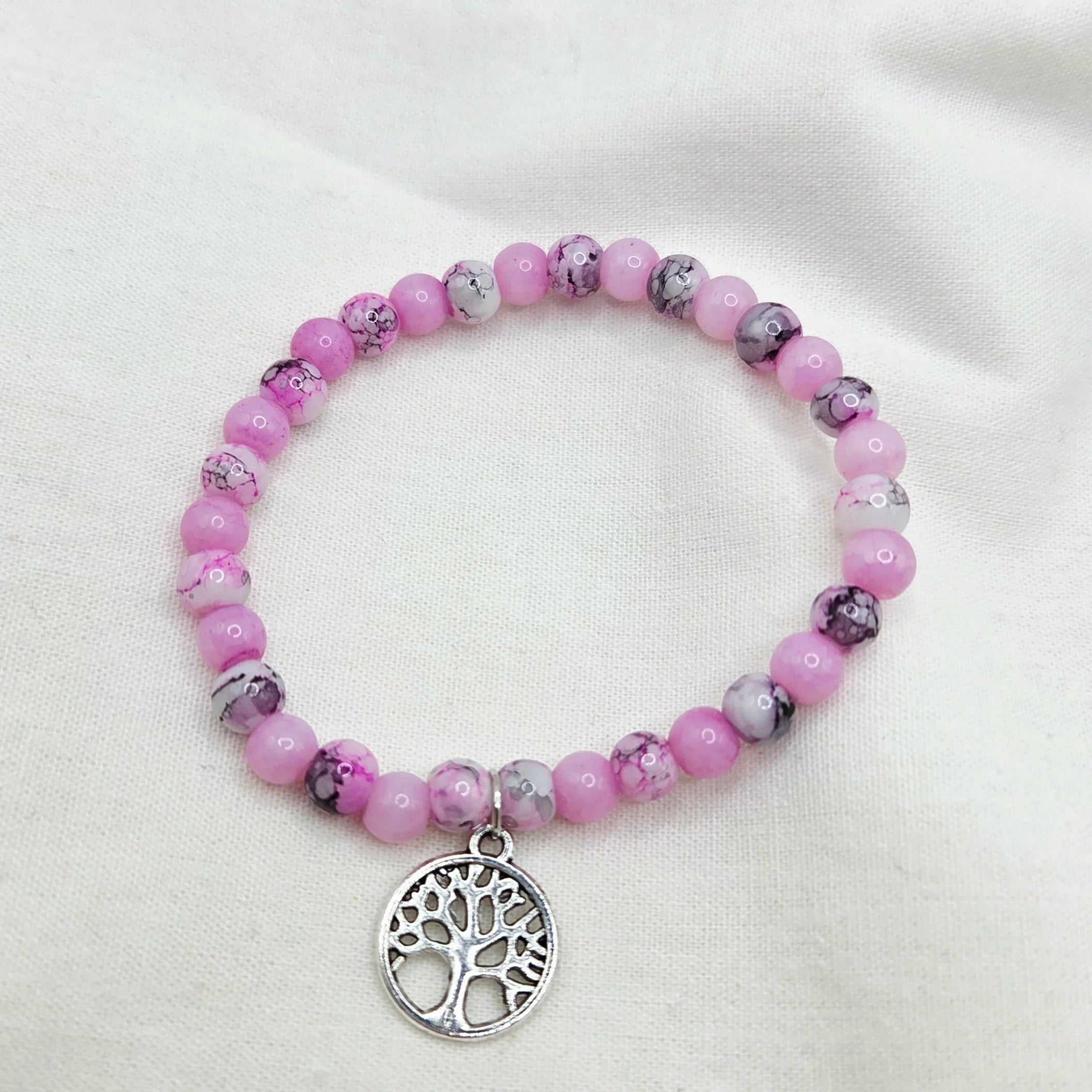 Pink beaded bracelet with tree of life charm, handmade for cozy, creative gifting