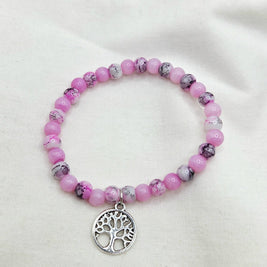 Pink beaded bracelet with tree of life charm, handmade for cozy, creative gifting
