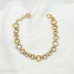 Two-tone gold and silver chainmaille bracelet with lobster clasp on white fabric