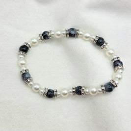 Elegant pearl and black bead bracelet with crystal accents, perfect for cozy handmade gifts