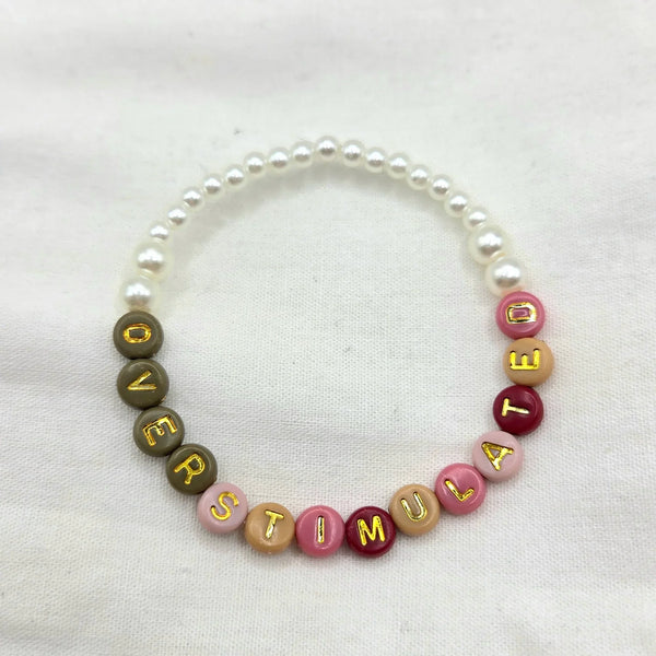 Overstimulated beaded bracelet with colorful letter beads and pearls, handmade for cozy everyday wear