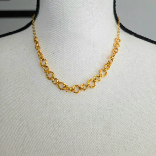 Gold chain link necklace on white mannequin, elegant everyday jewelry for women