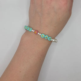 Handmade 'Need a Nap' beaded bracelet with mint, pink, and pearl beads on wrist