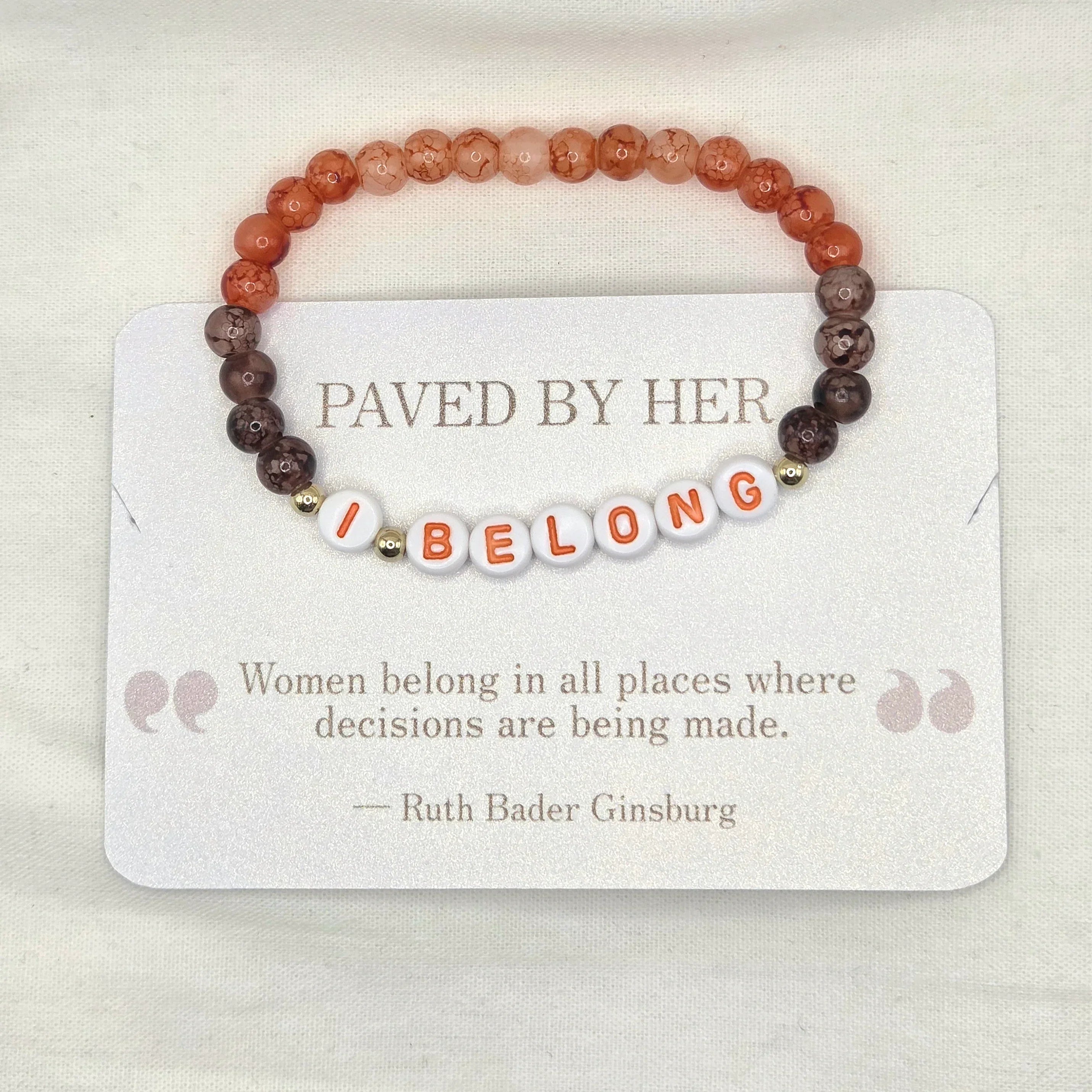 I BELONG beaded bracelet with orange and brown stones, displayed on a card with Ruth Bader Ginsburg quote.